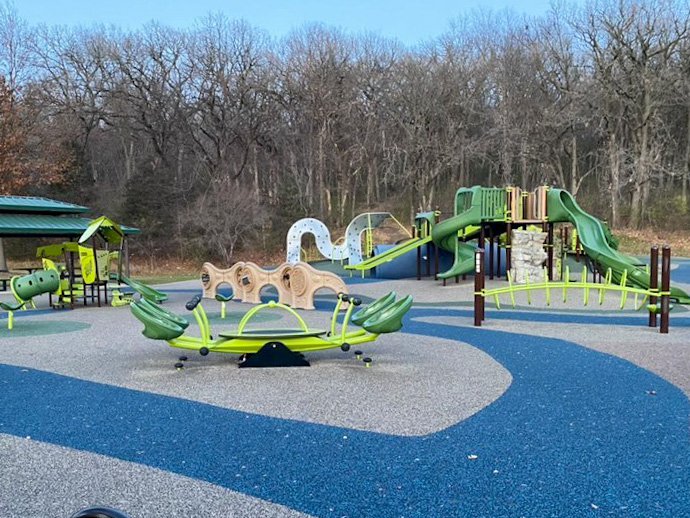The green-themed playground equipment at Madison&#x27;s Place Playground.