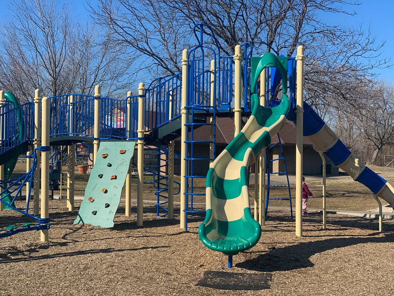 Playground equipment at Veterans Park in Richfield, including a slide, climbing platform, and elevated walkway.